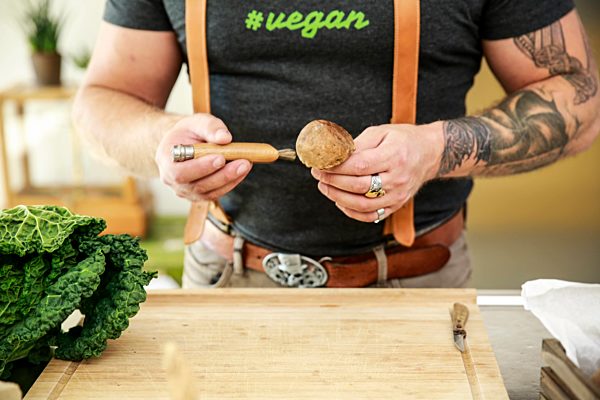 Vegan man cleaning mushrooms in his kitchen