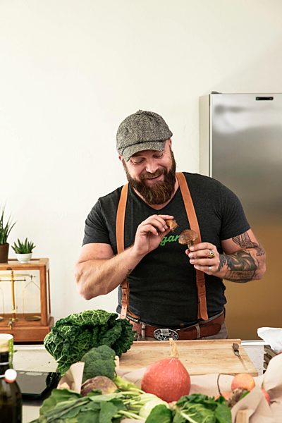Vegan man cleaning mushrooms in his kitchen