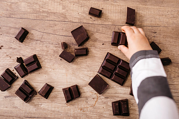 Boy's hand taking piece of chocolate