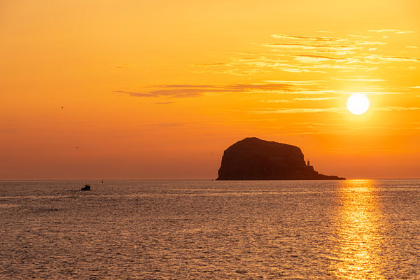 Great Britain, Scotland, East Lothian, North Berwick, Firth of Forth, view of Bass Rock at sunrise, lighthouse