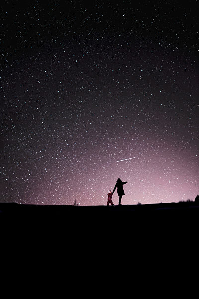 Finland, Kuopio, mother and daughter watching shooting star