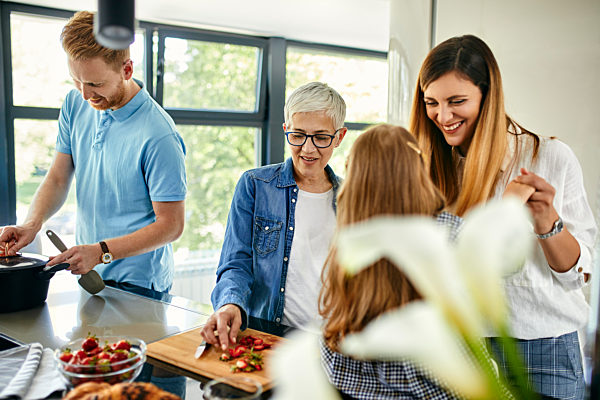 Three genaration family preparing food in kitchen