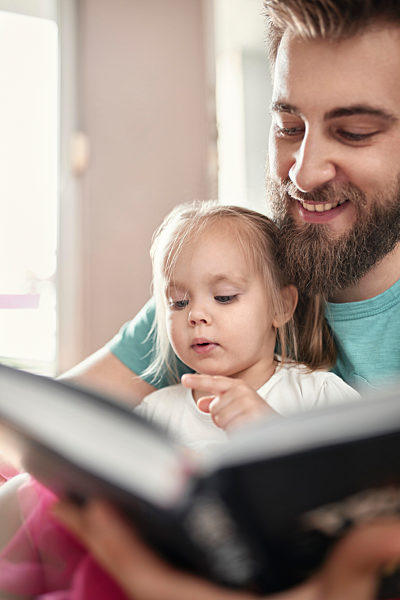 Father and daughter reading a book
