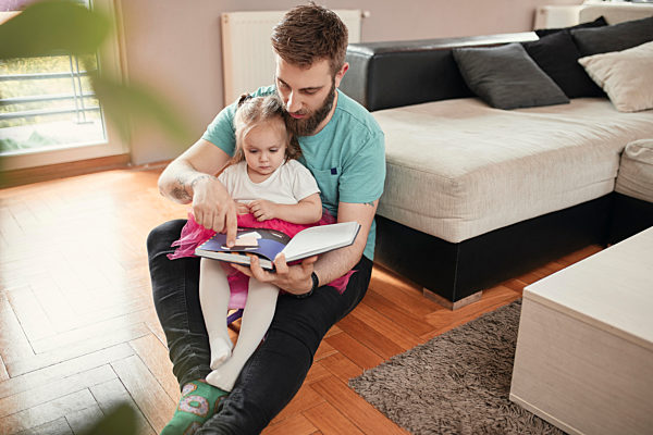 Father and daughter reading a book