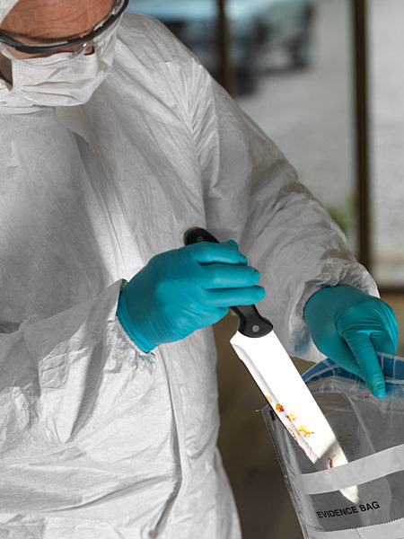 Forensic scientist bagging a knife taken from a violent crime scene