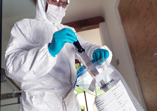 Forensic scientist bagging a knife taken from a violent crime scene
