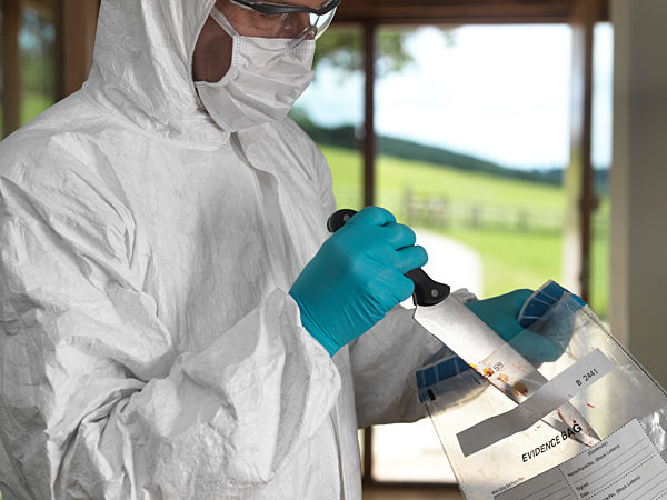 Forensic scientist bagging a knife taken from a violent crime scene