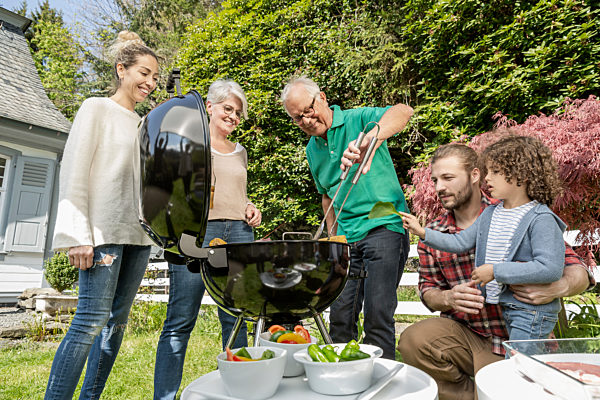 Extended family having a barbecue in garden