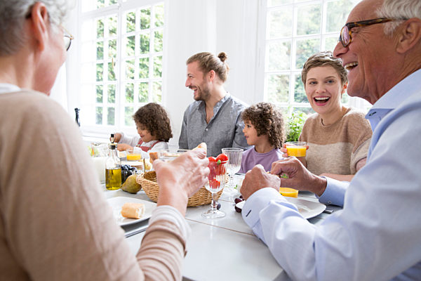 Happy extended family having lunch at home