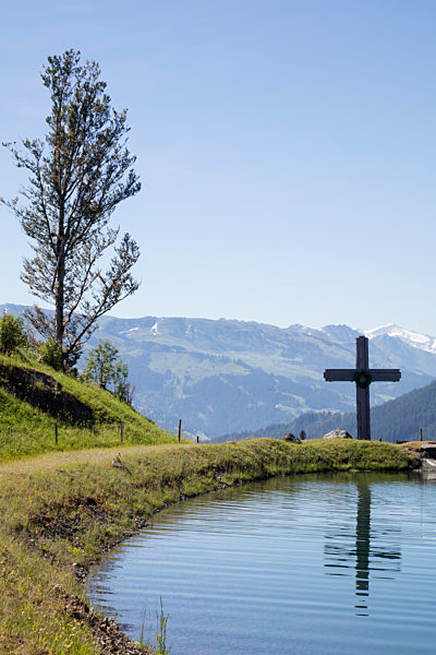 Cross by Astbergsee lake against clear sky at Astberg, Kitzbühel, Tyrol, Austria
