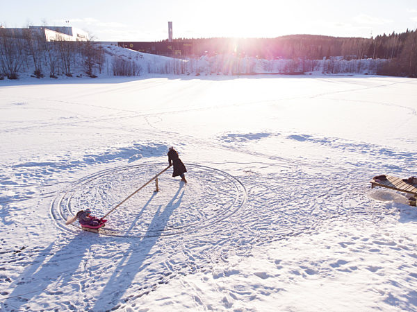 Finland, Kuopio, high angle view of mother and daughter playing in snow