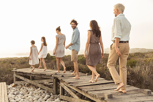 Large family enjoying the sunset on a boardwalk