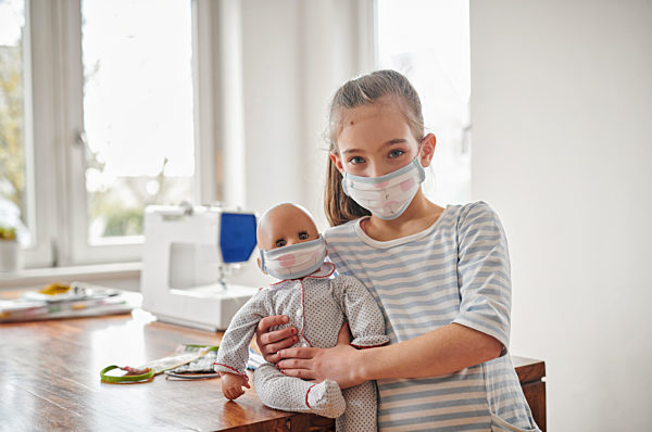 Little girl and her doll, wearing self.made face masks