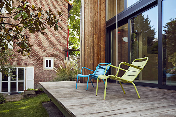 Empty chairs on hardwood floor outside tiny house