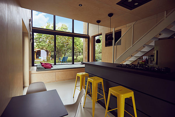 Empty yellow stools by kitchen counter in tiny house