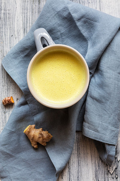 Golden milk with root kept on napkin