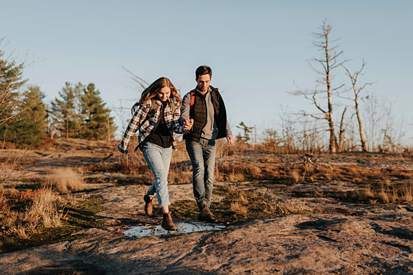 Young couple holding hands during autumn hike