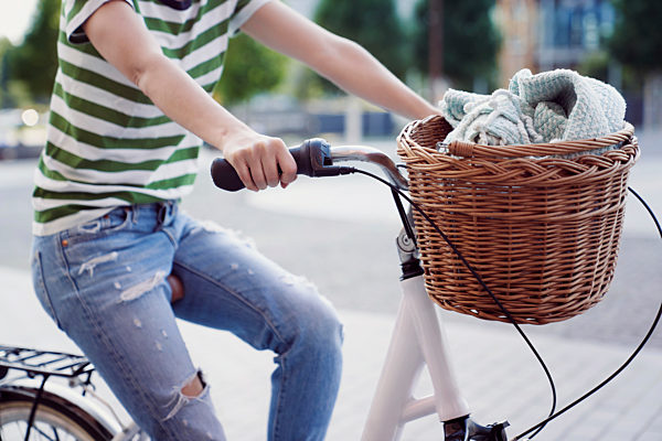 Woman cycling in city during weekend