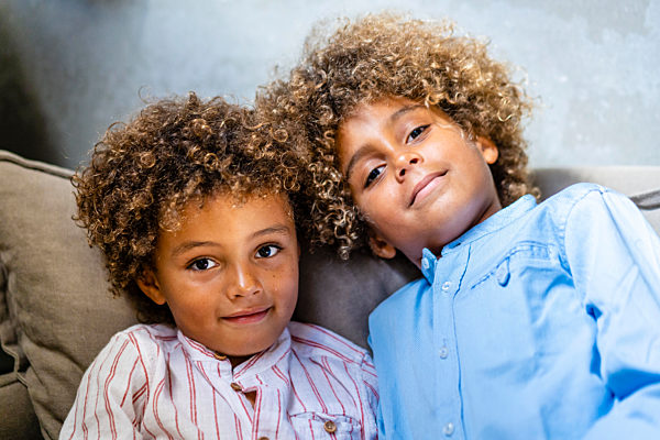 Boys relaxing on sofa at home