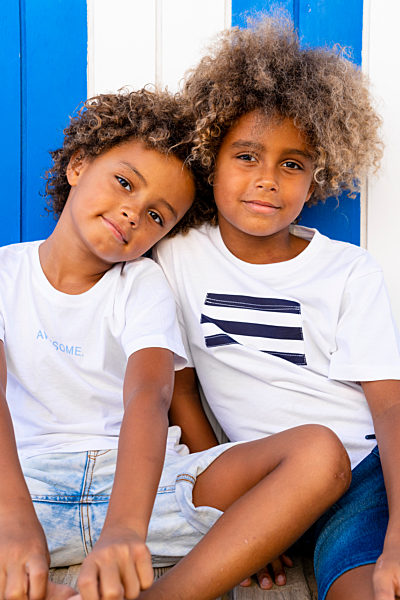 Cute boy leaning on shoulder of brother