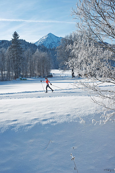 Mature woman skiing on snow during vacation