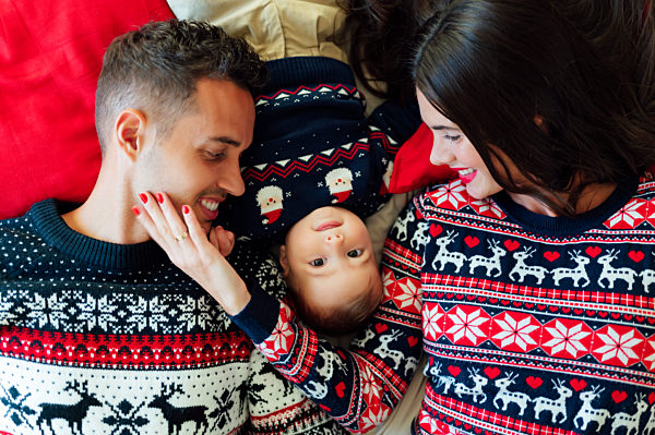 Happy family lying on bed at home during Christmas