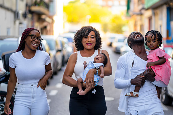Happy family walking together on road