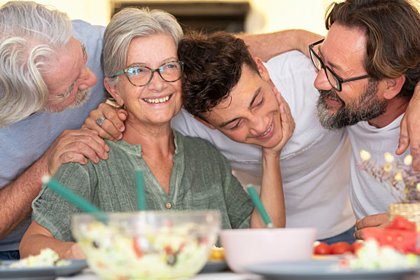 Happy family with arm around each other at dining table