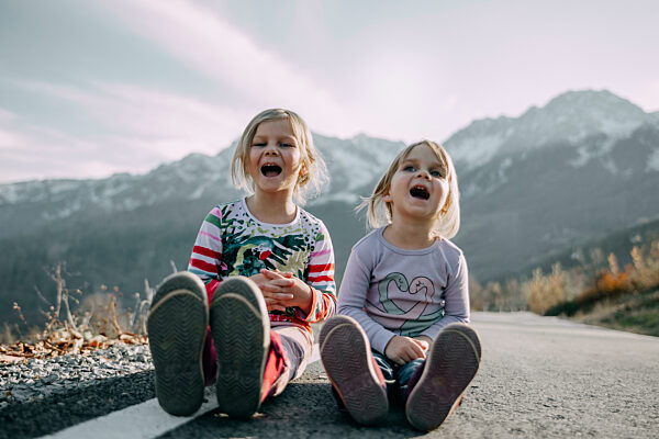 Blond sisters screaming on road