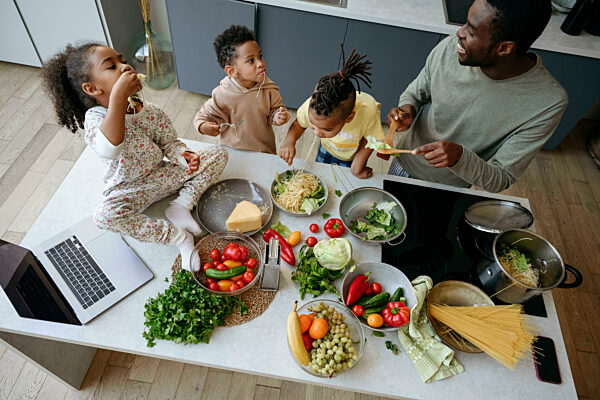Family eating spaghetti at home