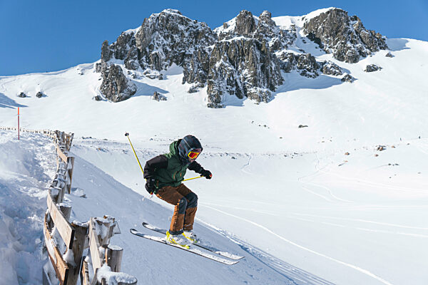 Young tourist skiing on snowcapped mountain