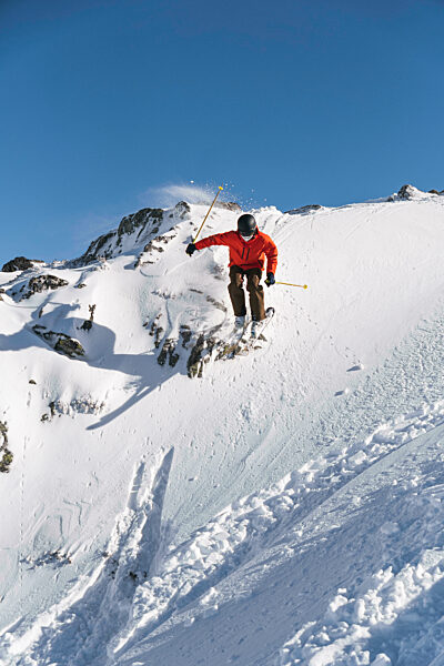 Tourist skiing on snowcapped mountain