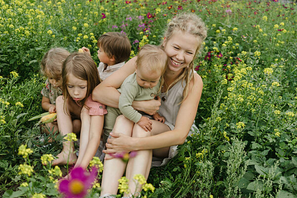 Happy family sitting amidst plants