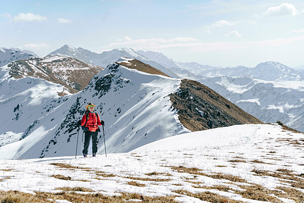 Hiker hiking on snow covered mountain, Caucasus Nature Reserve, Sochi, Russia