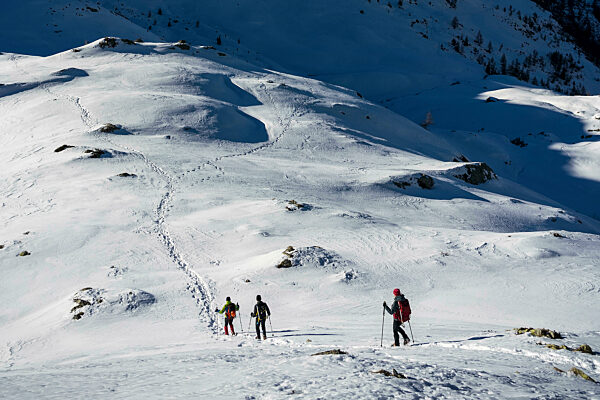 Ski mountaineerers moving down from snowy mountain at Orobic Alps in Valtellina, Italy
