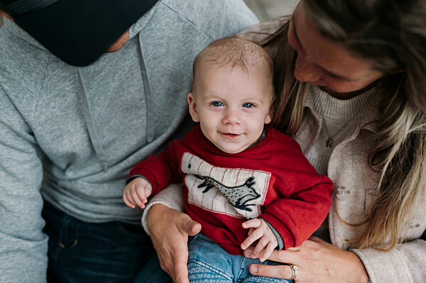 Cute boy sitting with parents