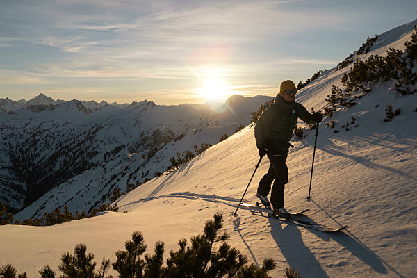 Man with ski pole walking on snowy mountain