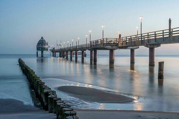 Germany, Mecklenburg-Western Pomerania, Zingst, Long exposure of Zingst Pier at dusk with Tauchgondel in background