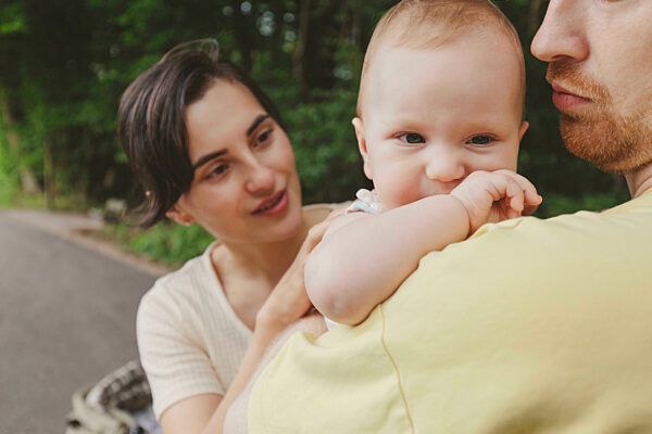 Mother and father with baby girl in park