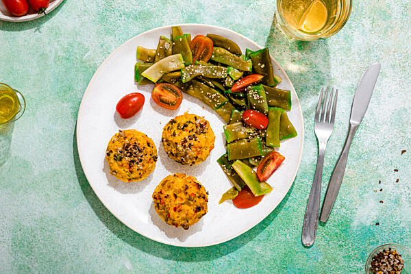 Plate of rice muffins with cherry tomato and green bean salad