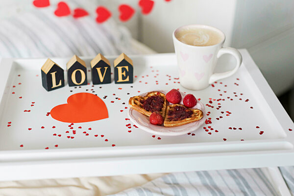 Love text by heart shape in breakfast tray