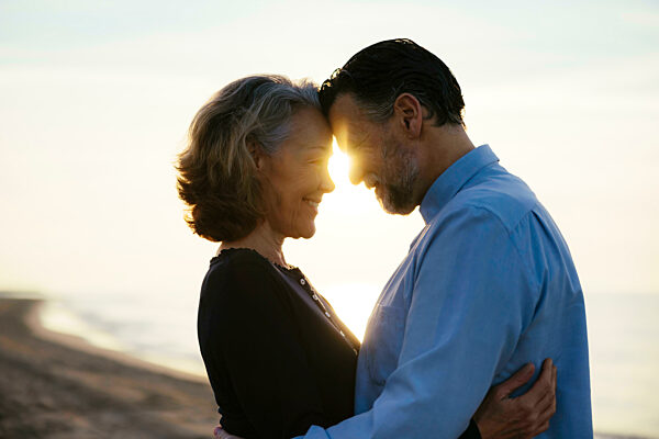 Happy couple enjoying and embracing each other at beach