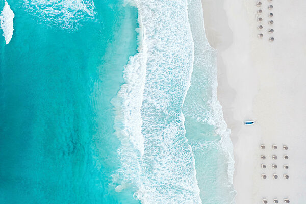Spain, Balearic Islands, Formentera, Drone view of rows of umbrellas on empty beach