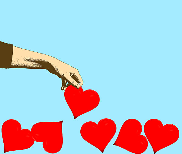 Hand picking up red heart