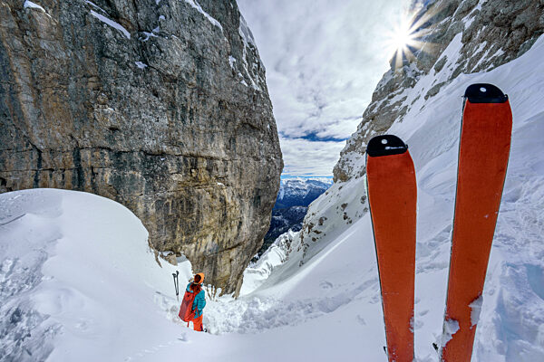 Ski with woman standing on Sassolungo Di Cibiana mountain in Dolomites at Veneto, Italy