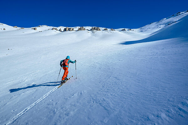 Woman backcountry skiing in the Appennines, Italy, enjoying freedom and tranquility.