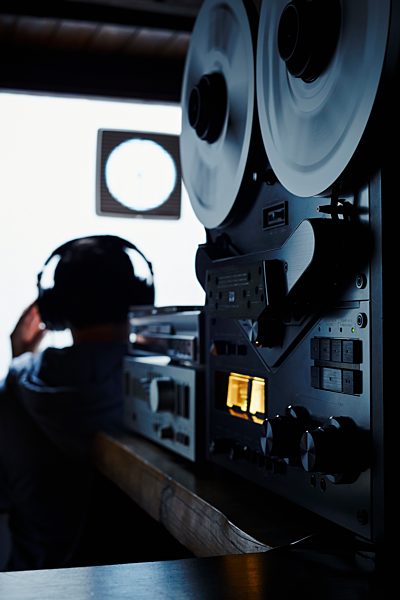 Germany, Bavaria, Man with head phone in recording studio