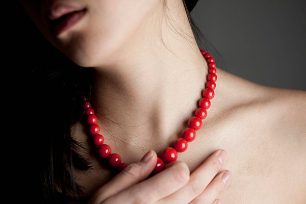 Japanese woman with red necklace, close up