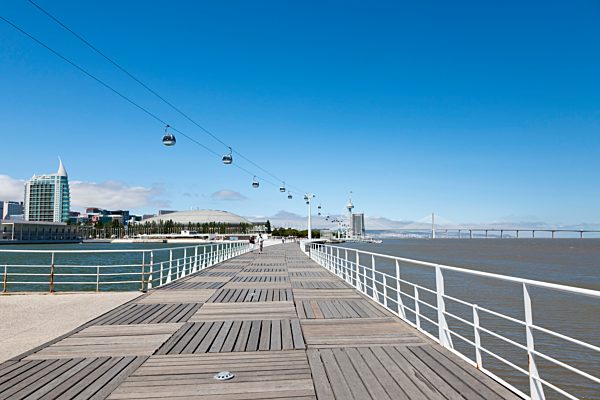 Europe, Portugal, Lisbon, Parque das Nacoes, View of Vasco da Gama bridge and Vasco da Gama tower with cable car over river Tagus