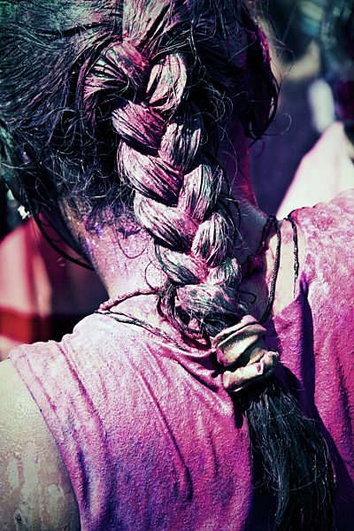 India, Ahmedabad, Coloured wet hair at Holi festival, close up